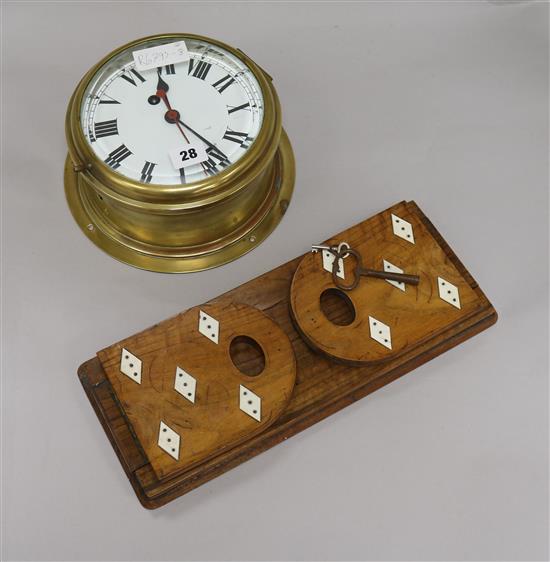 A brass ships timepiece and an adjustable bookslide